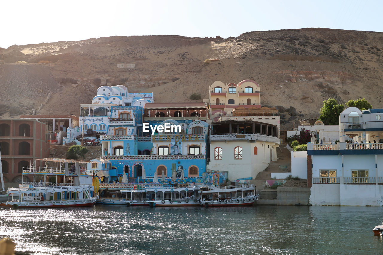 water, architecture, sea, nature, nautical vessel, building exterior, built structure, transportation, building, travel destinations, vacation, vehicle, travel, land, mountain, tourism, sky, beach, no people, house, mode of transportation, coast, town, day, outdoors, city, waterway, landscape, waterfront, ship, environment, boat, holiday, residential district, trip, clear sky, village, coastline, harbor