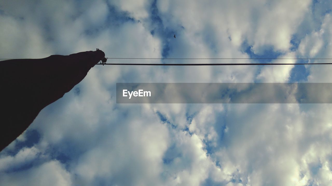 LOW ANGLE VIEW OF HUMAN HAND AGAINST SKY