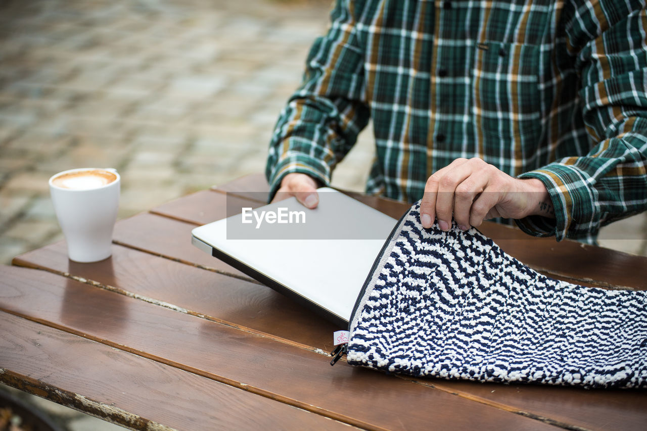 Woman putting laptop into case