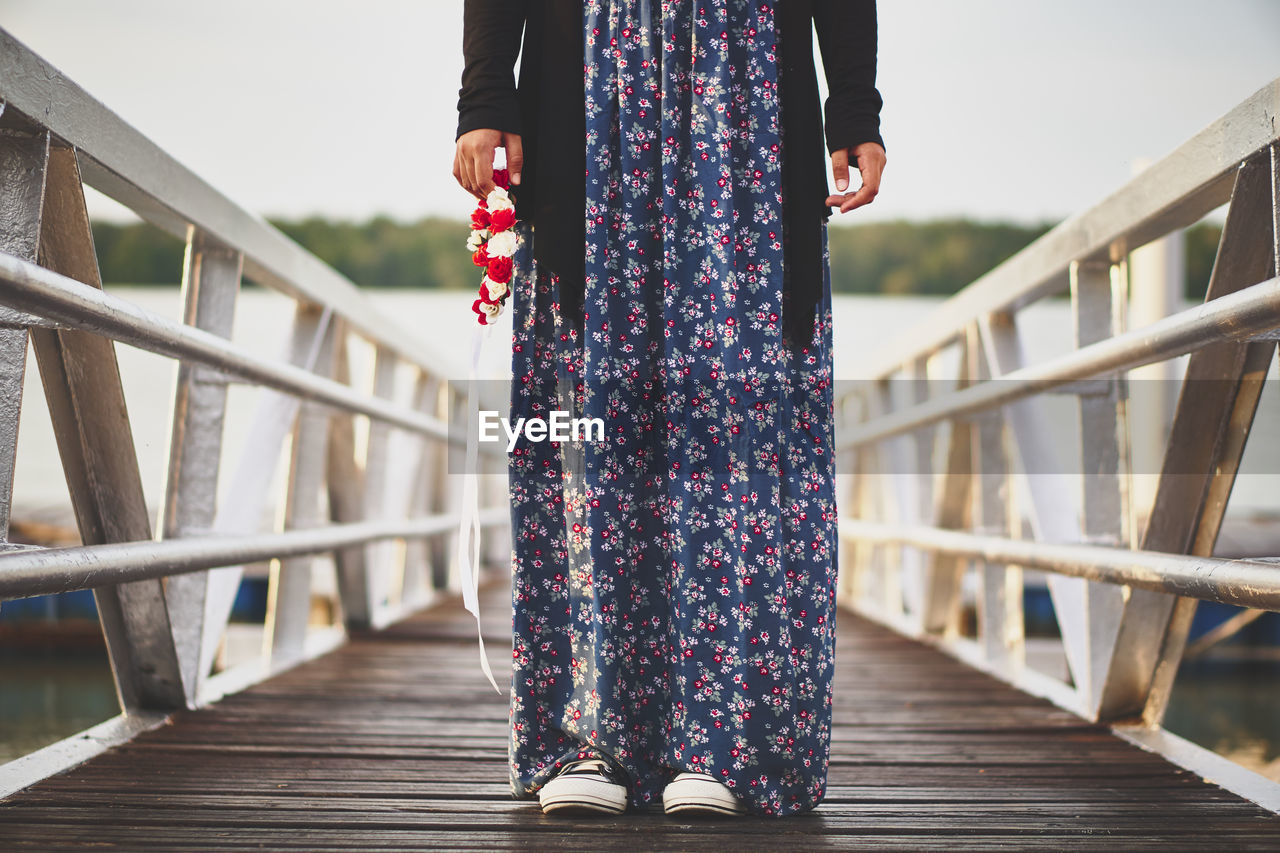 Low section of woman on pier