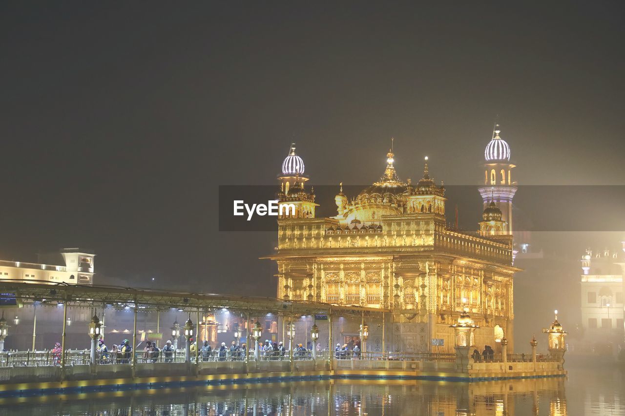 Illuminated buildings against sky at night, golden temple amritsar 