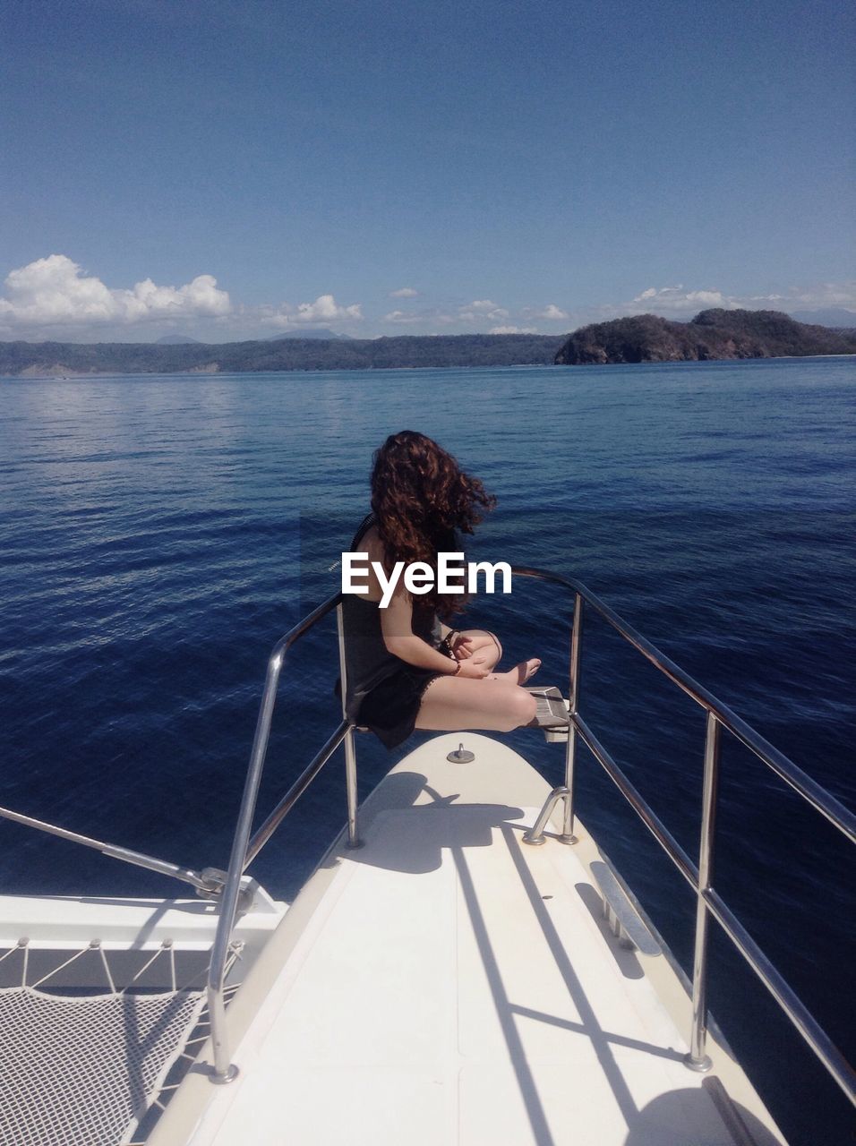 Woman looking at sea against sky