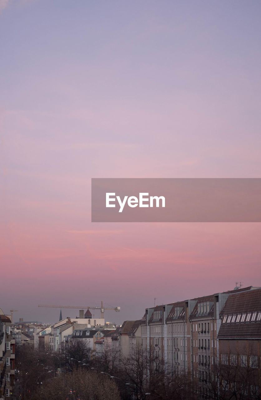 BUILDINGS IN CITY AGAINST SKY DURING SUNSET