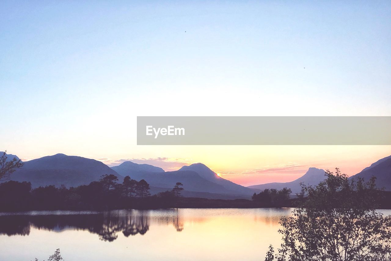 Scenic view of lake against sky during sunset