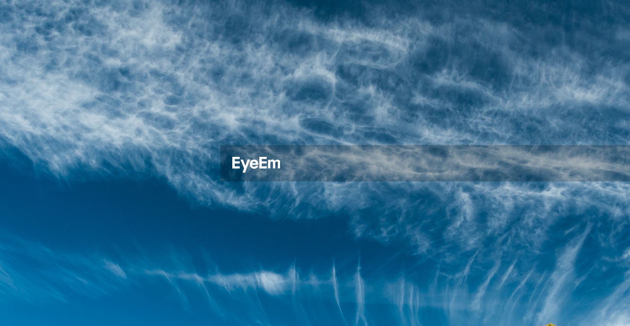 Aerial view of vapor trails in blue sky