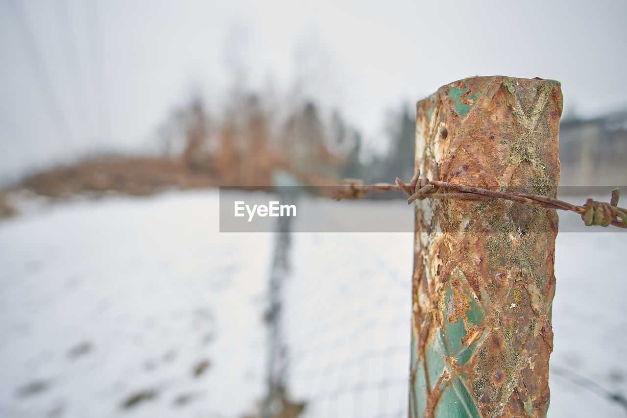 Close-up of rusty barbed wire during winter