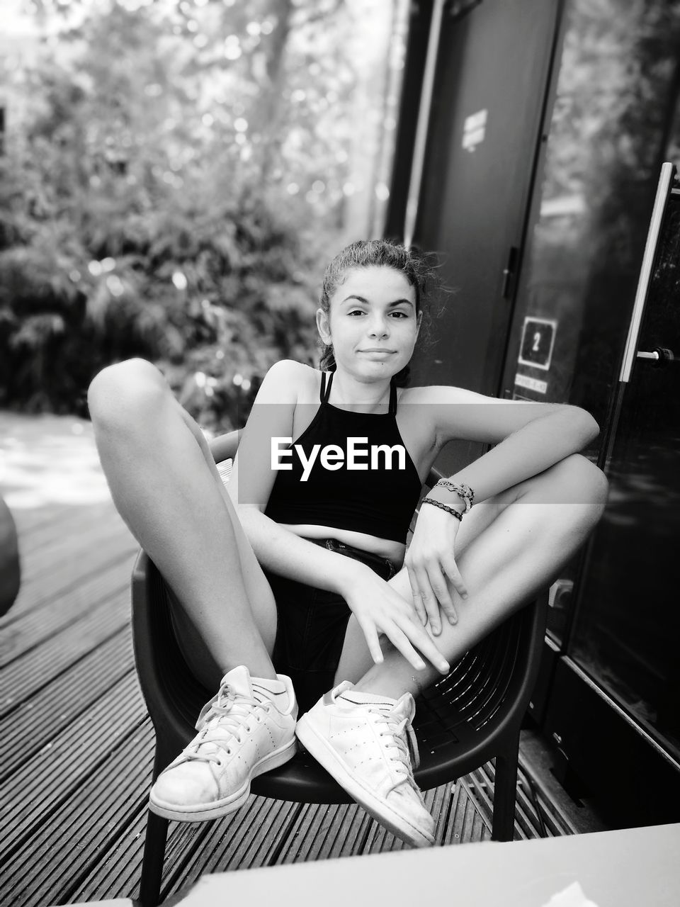 Portrait of young woman sitting on chair