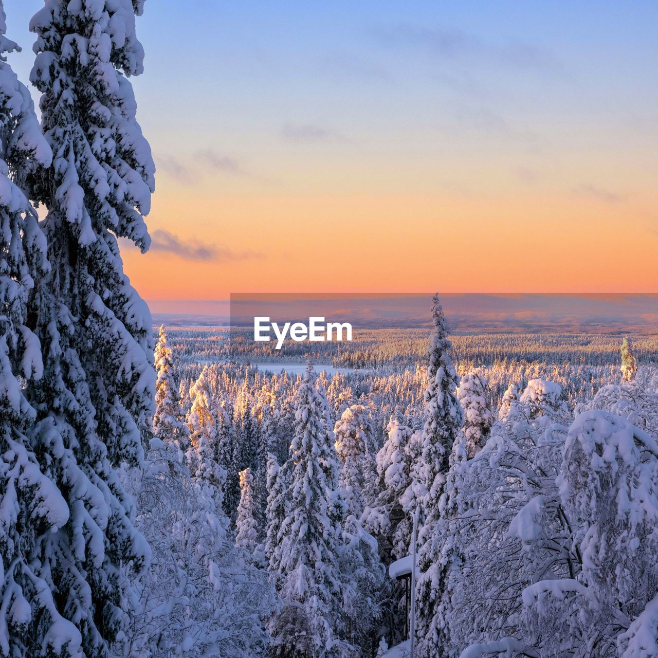 scenic view of snow covered land against sky during sunset