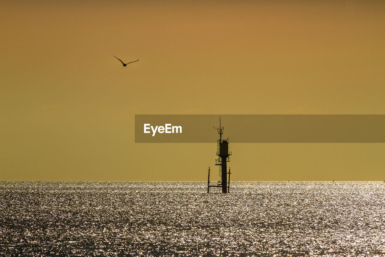 VIEW OF LIGHTHOUSE AGAINST SKY DURING SUNSET