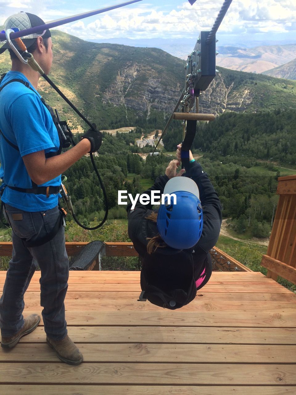 WOMAN STANDING ON MOUNTAIN