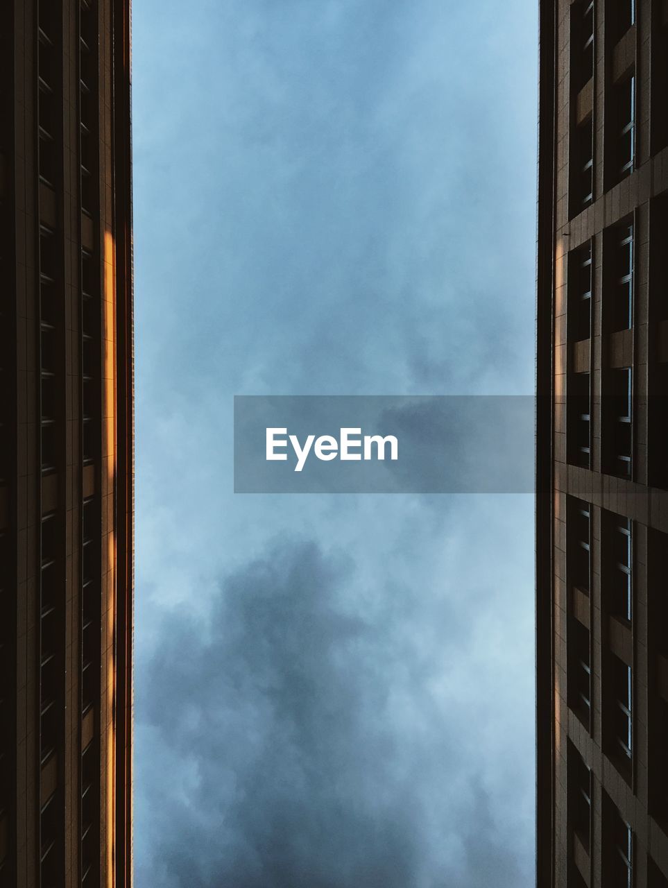 Directly below view of buildings against sky at dusk