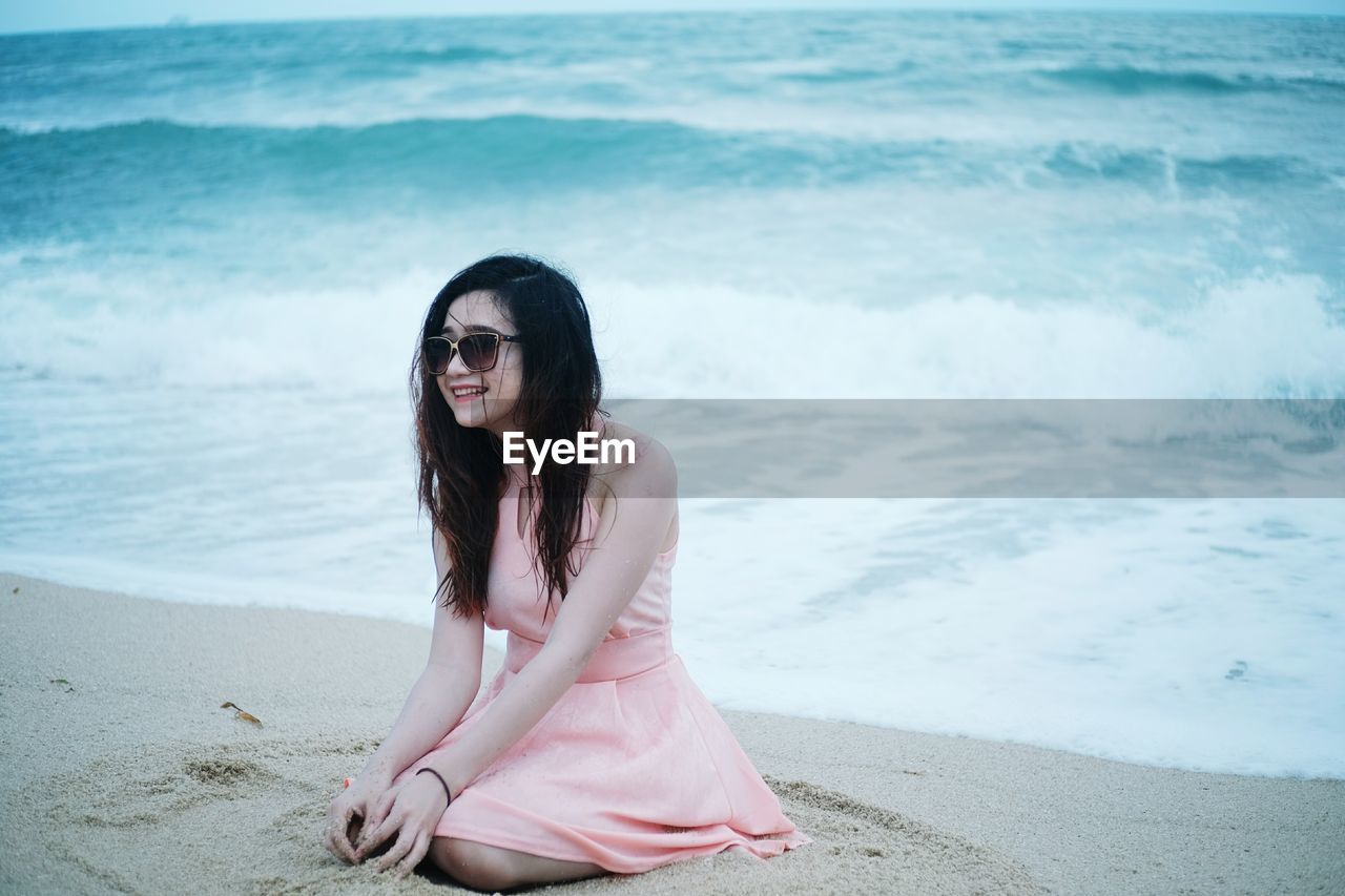 Portrait of smiling young woman on beach