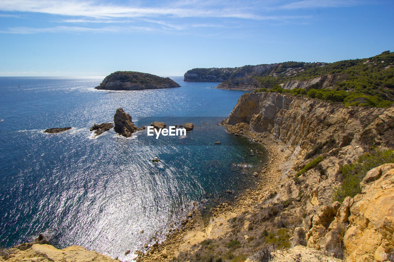 High angle view of rocks on beach against sky