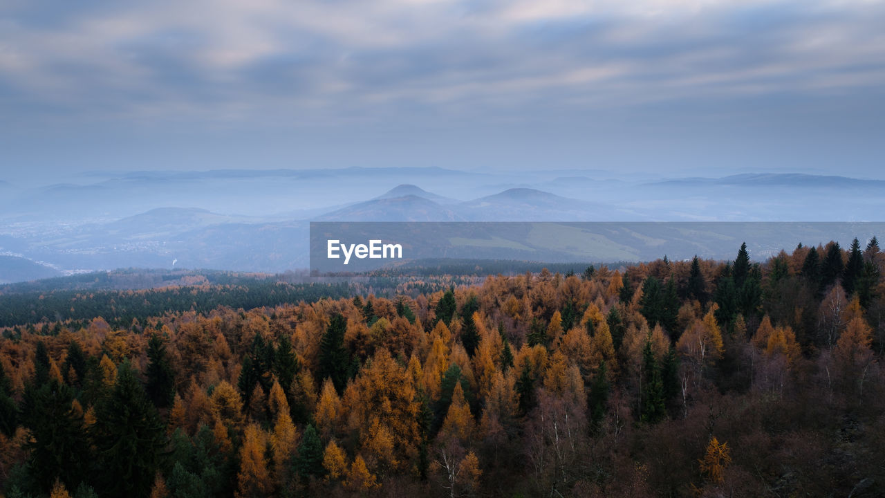 Scenic view of mountains against cloudy sky