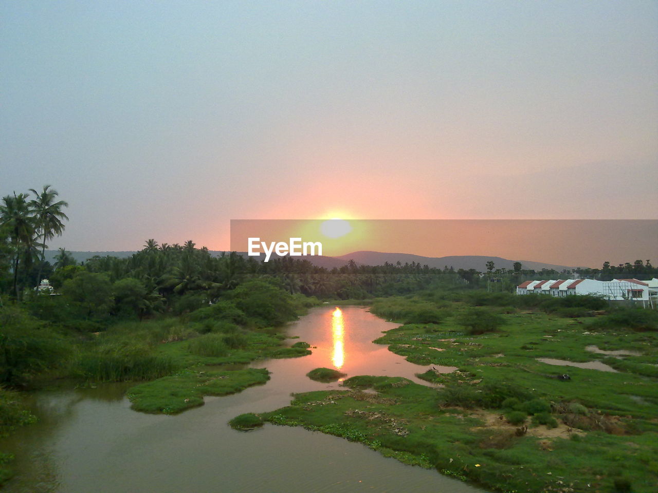 SCENIC VIEW OF SUNSET OVER RIVER