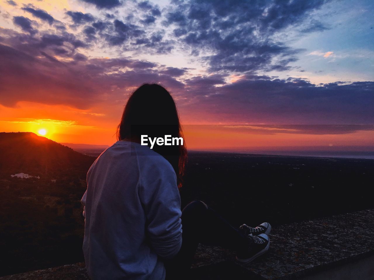 Woman against sky during sunset