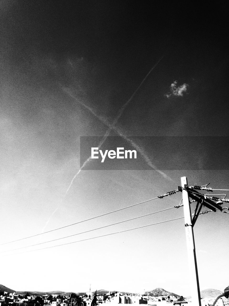 Low angle view of electricity pylon against sky