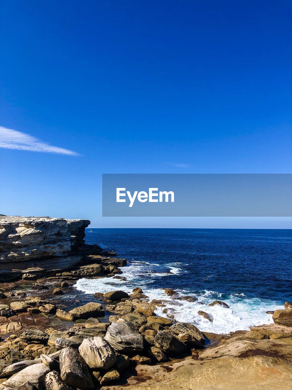 Scenic view of sea against blue sky