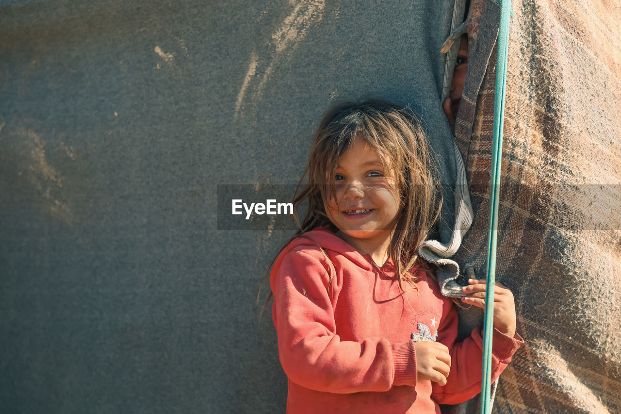 Portrait of young girl in a syrian refugee camp. 