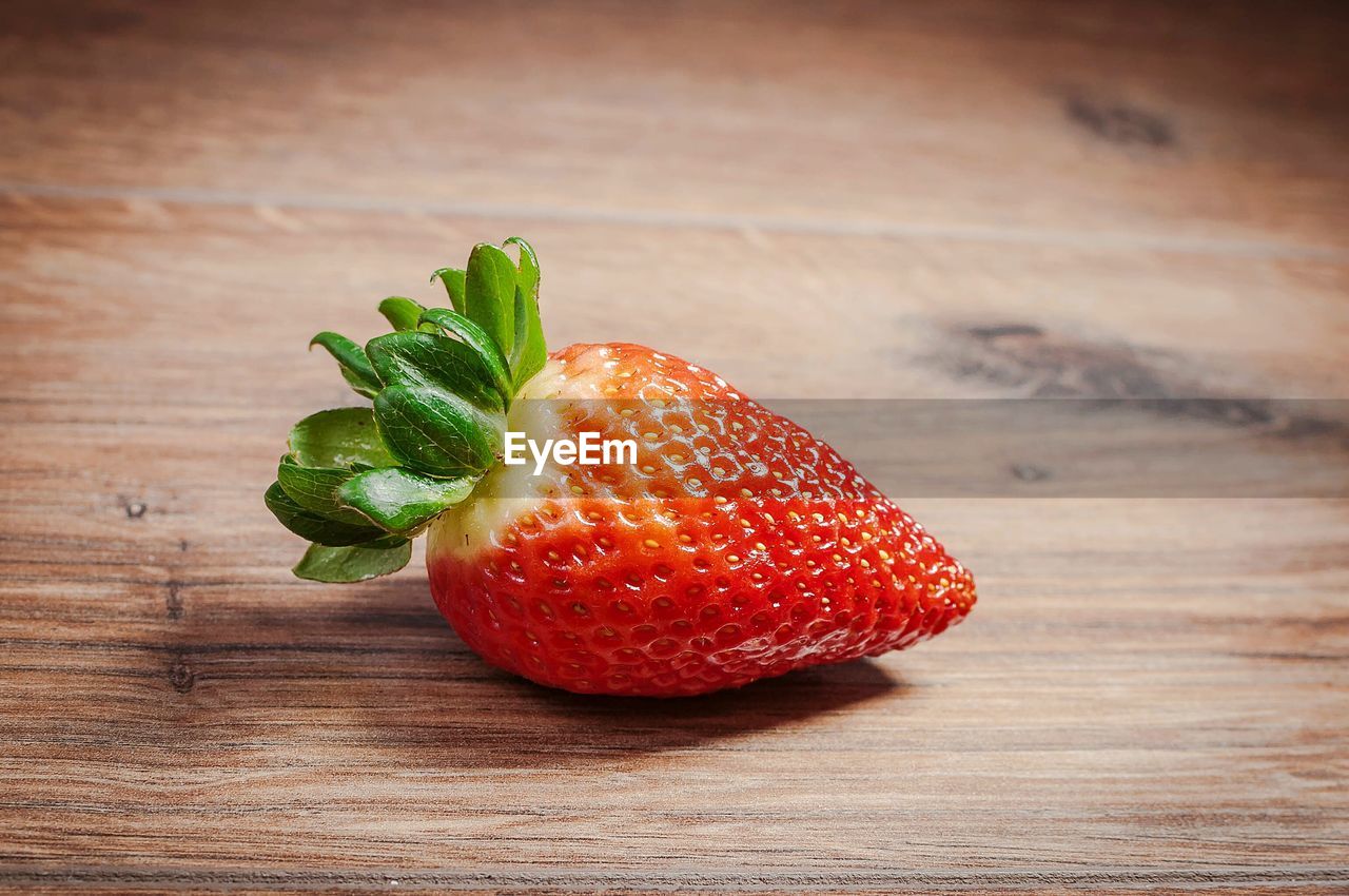 Close-up of strawberry on wooden table