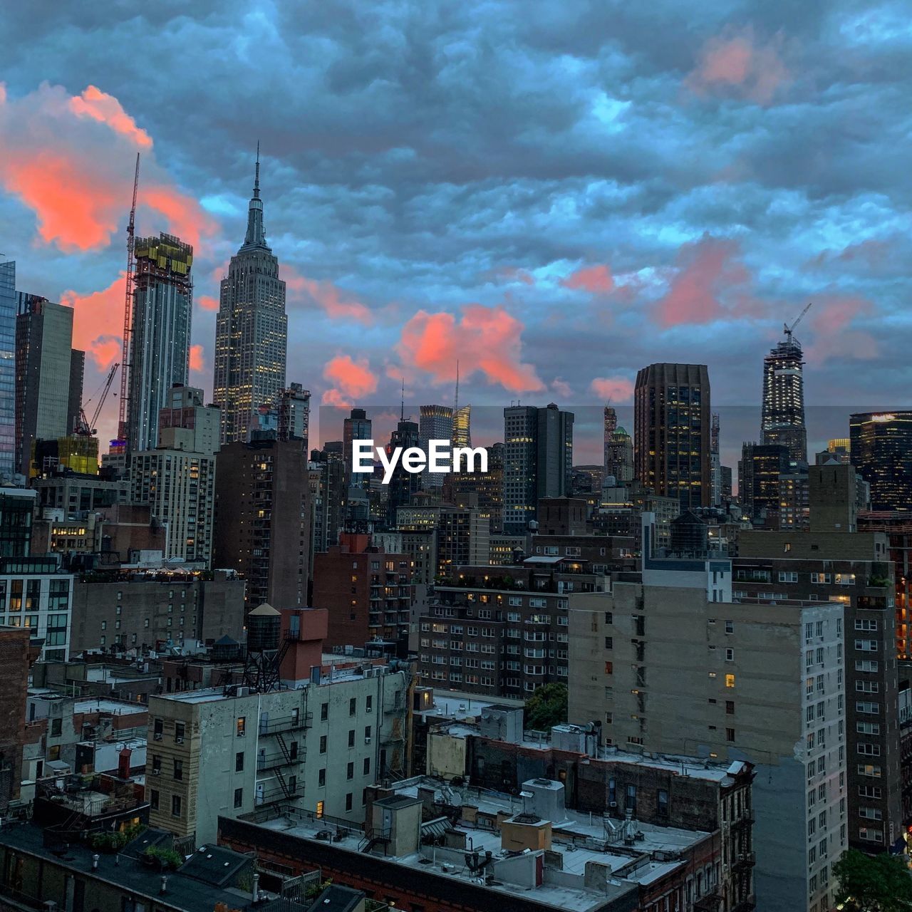 AERIAL VIEW OF MODERN BUILDINGS AGAINST SKY IN CITY