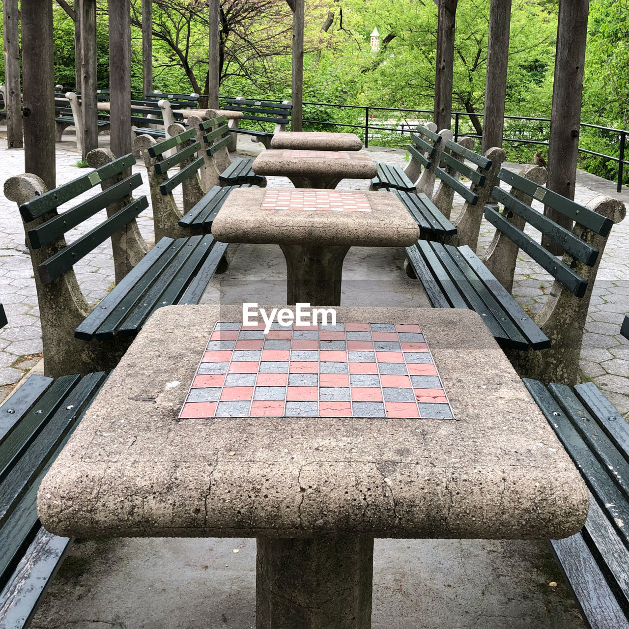 HIGH ANGLE VIEW OF EMPTY BENCHES IN PARK