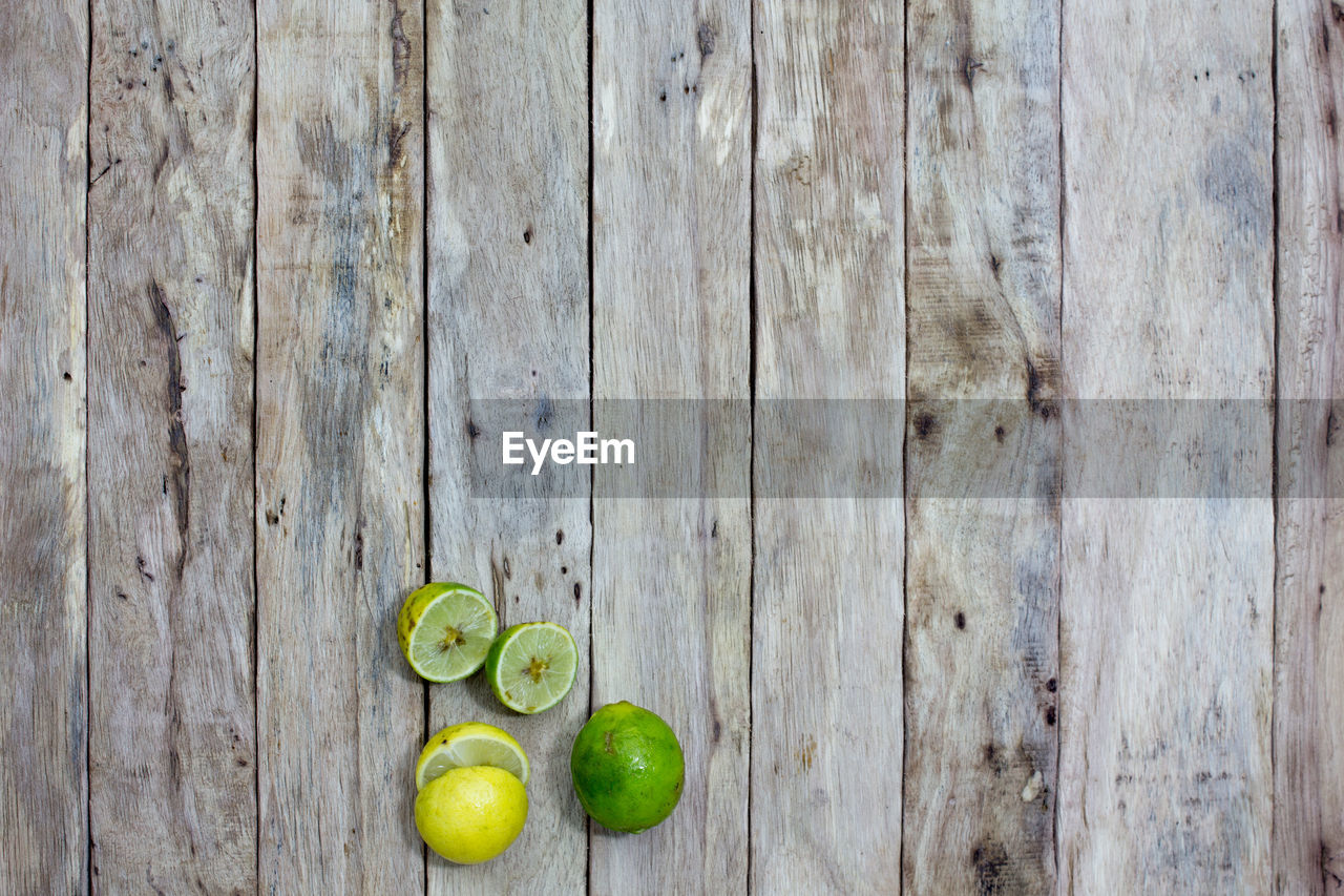 Close-up of sliced limes on wooden table