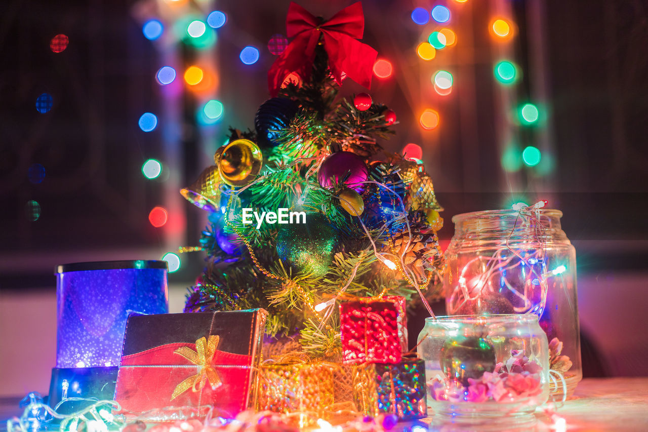 Close-up of illuminated christmas decorations on table