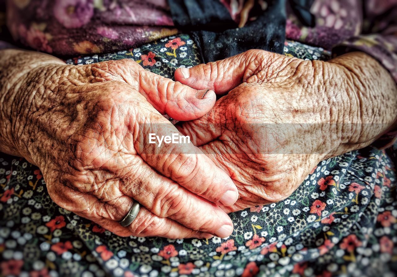 Midsection of senior woman with hands on stomach