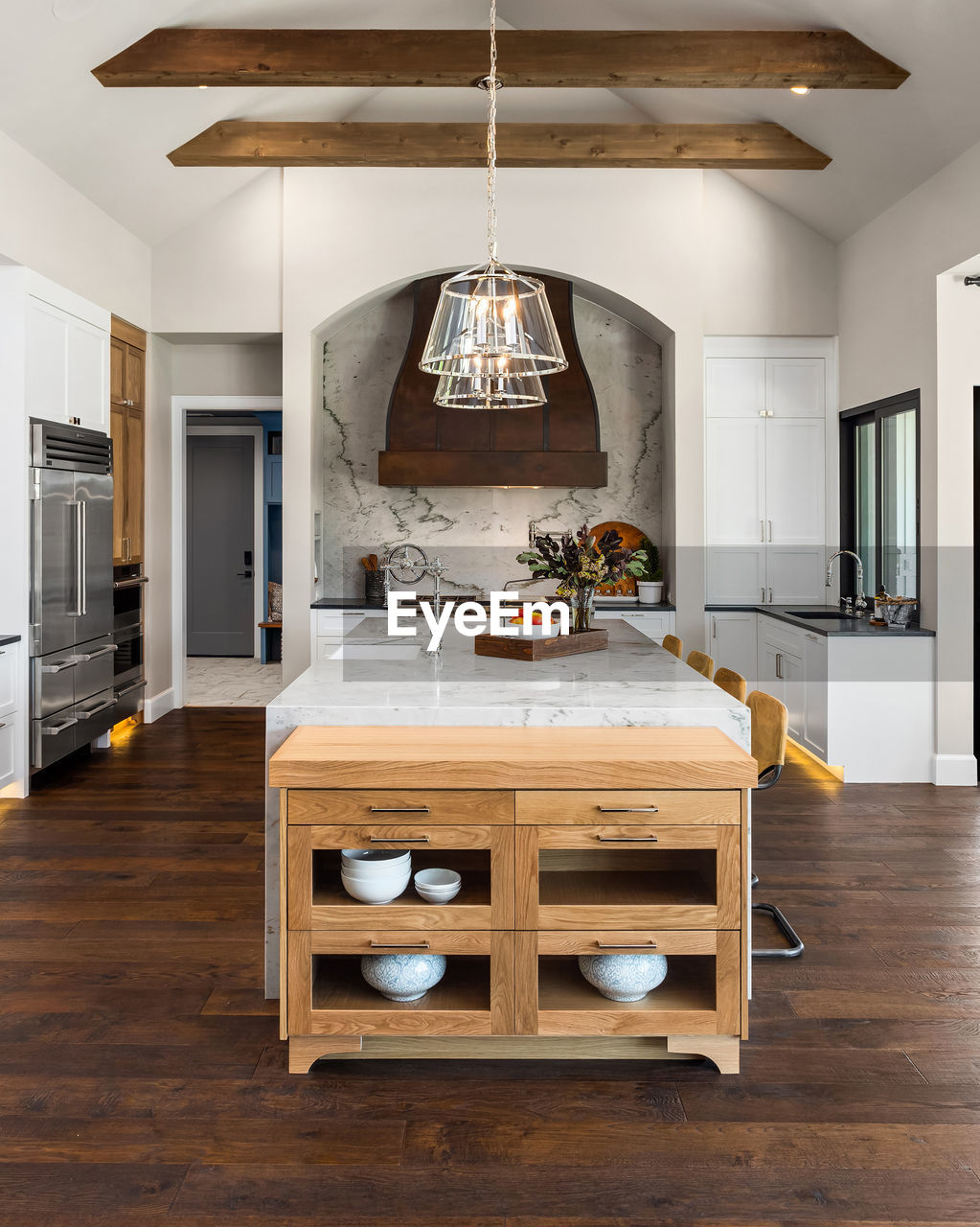 Kitchen in luxury home with large island and hardwood floors