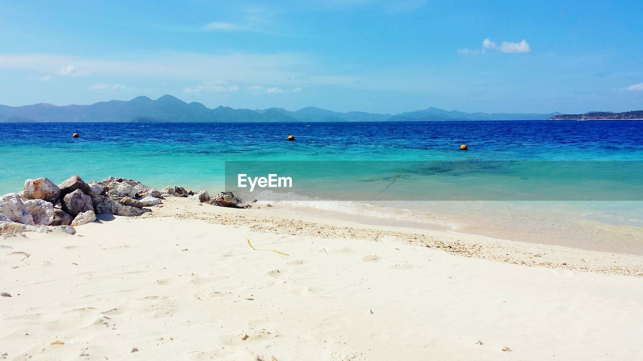 Beach against blue sky