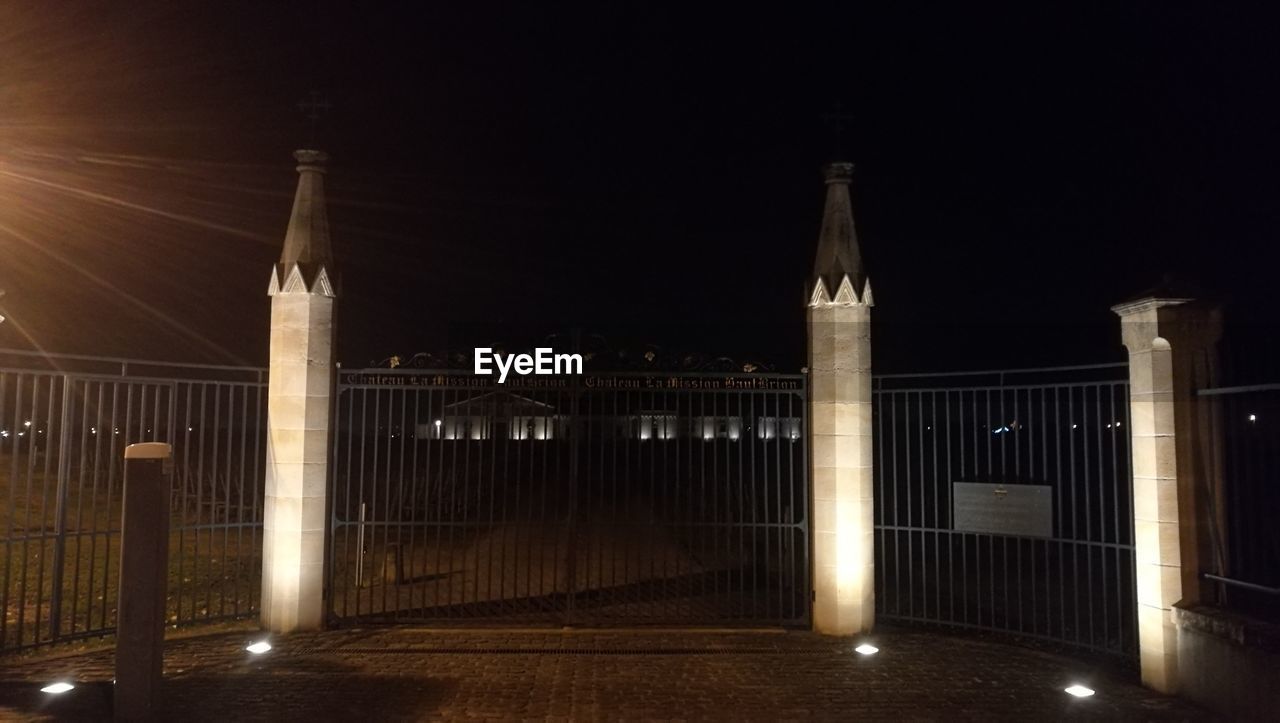 ILLUMINATED BUILT STRUCTURE AGAINST DARK SKY