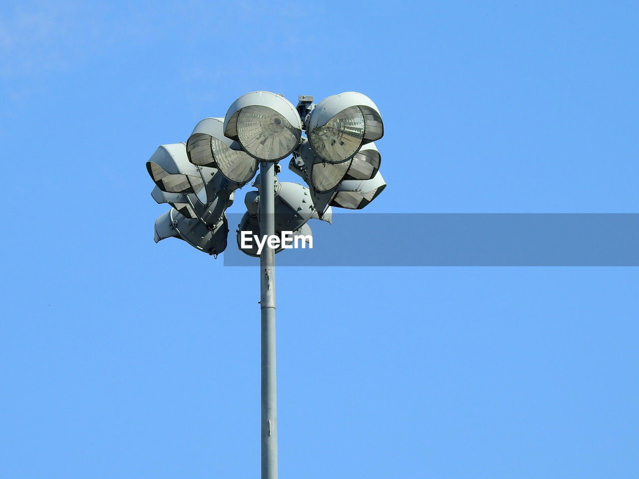 Low angle view of floodlight against clear blue sky