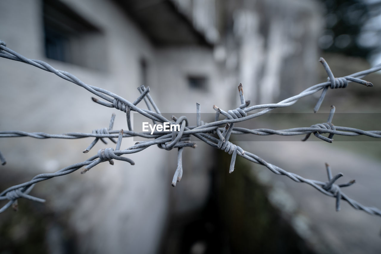 close-up of barbed wire against blurred background