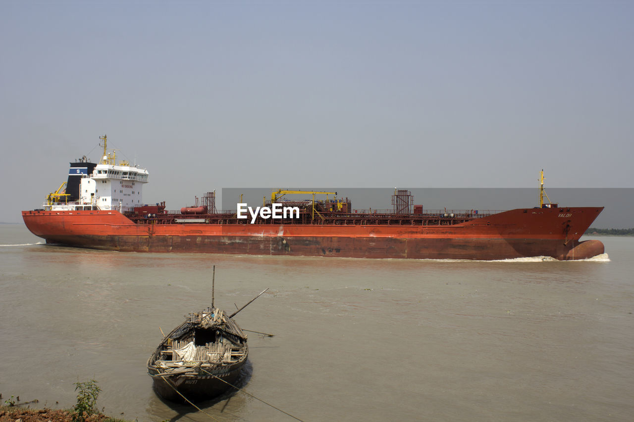 SHIP MOORED ON SEA AGAINST CLEAR SKY