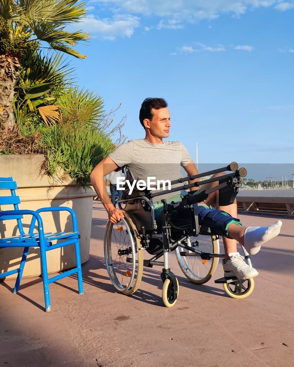 Portrait of young man sitting on wheelchair