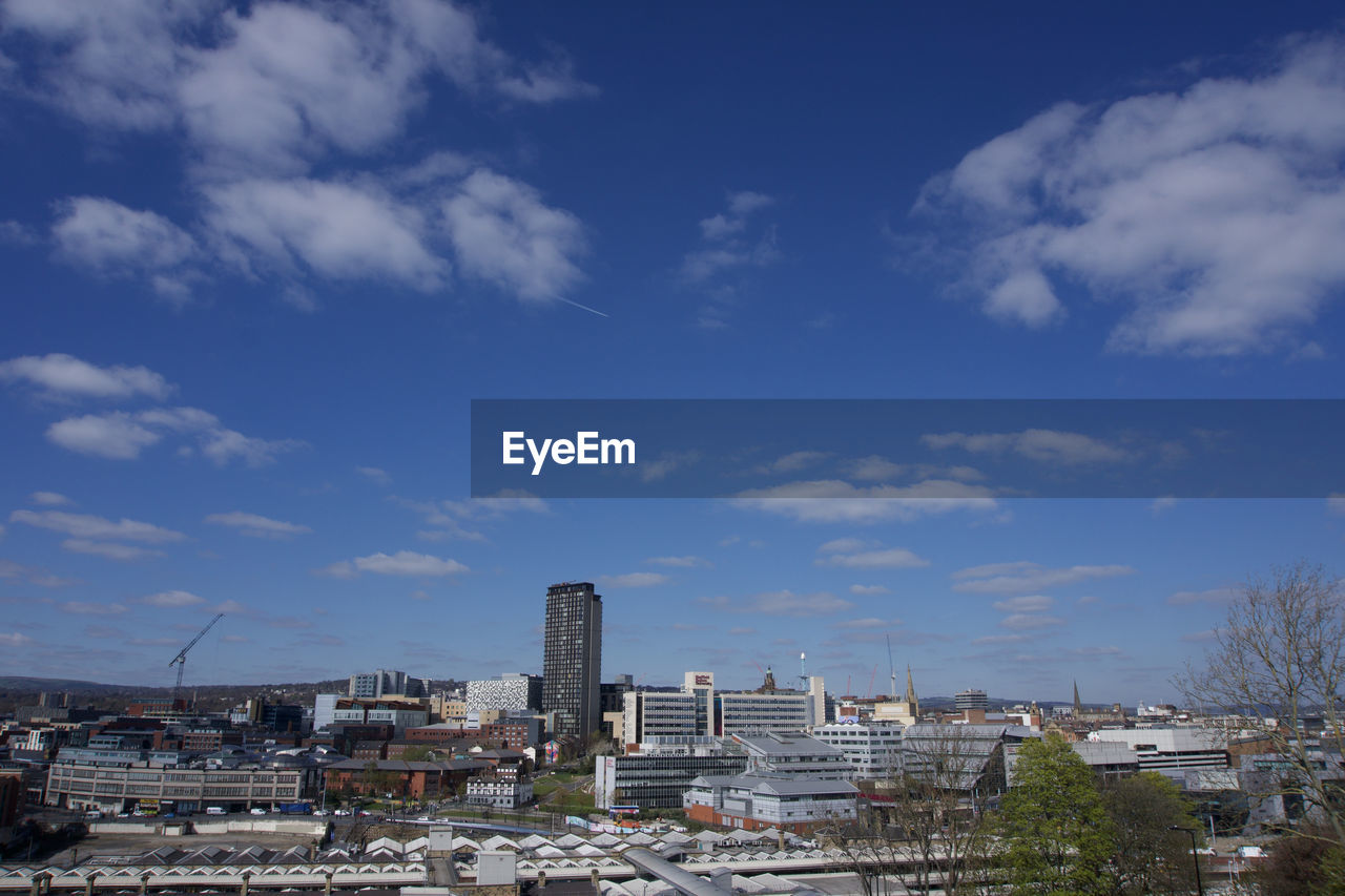 High angle view of sheffield city centre buildings against blue sky