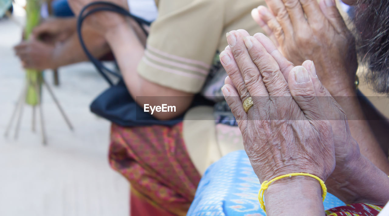 Close-up of people on hands