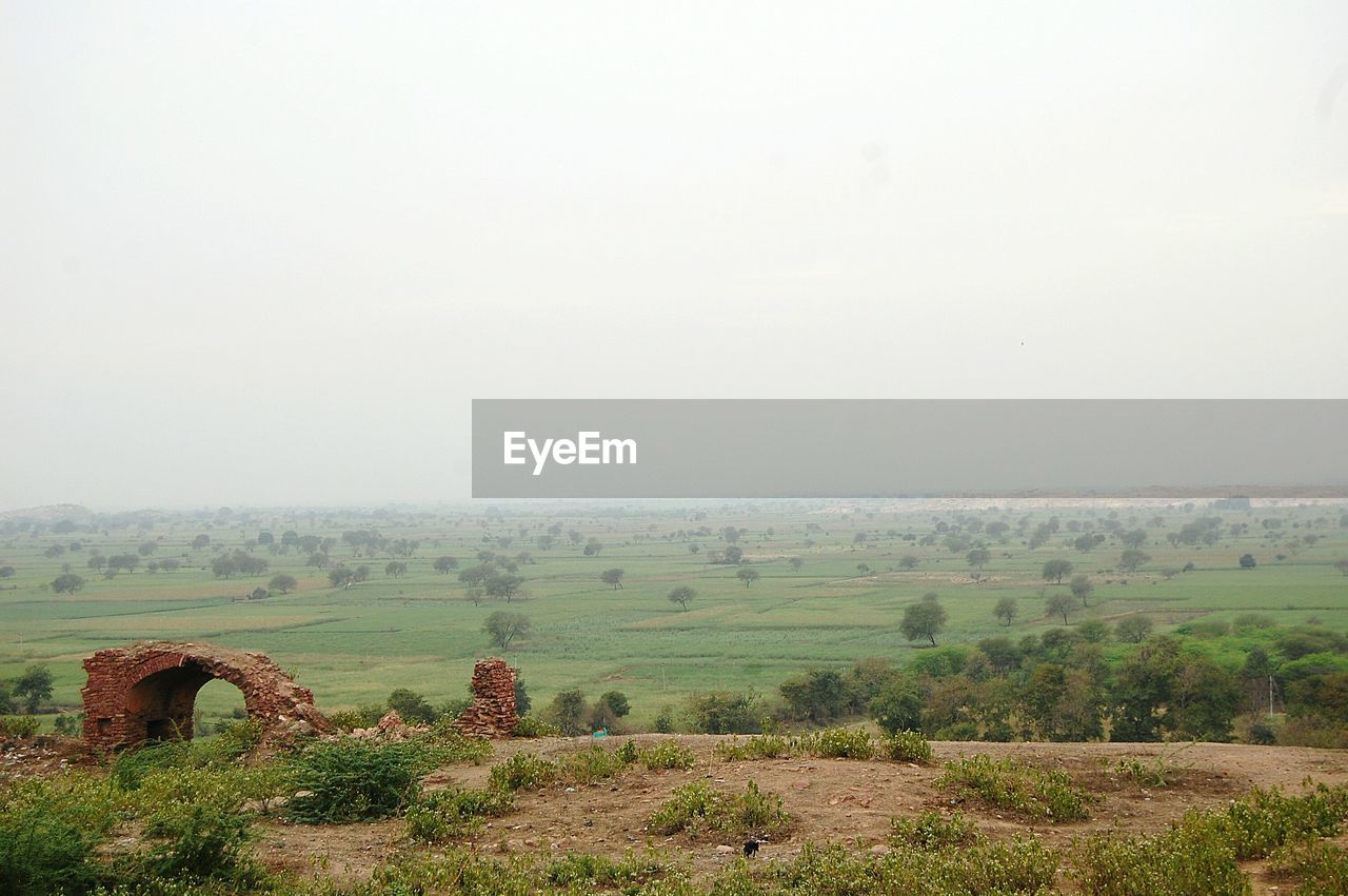 Scenic view of grassy field against cloudy sky