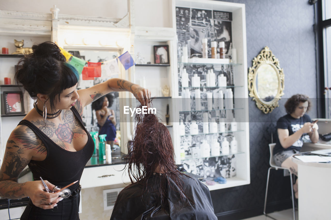 A hair dresser styling a customer's hair.