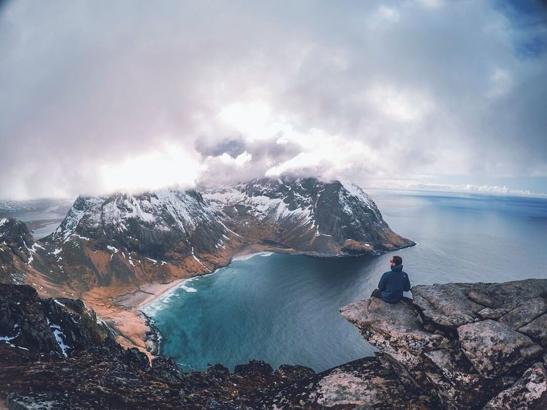 SCENIC VIEW OF SEA AND MOUNTAINS AGAINST CLOUDY SKY