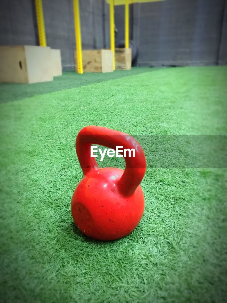Close-up of red kettlebell on grass