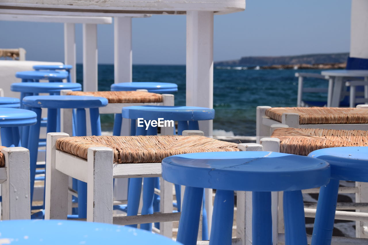 Chairs and tables at restaurant at paros