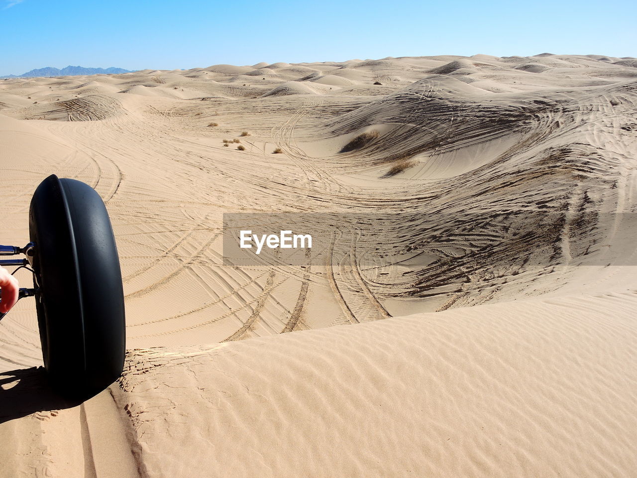 TIRE TRACKS ON SAND DUNES