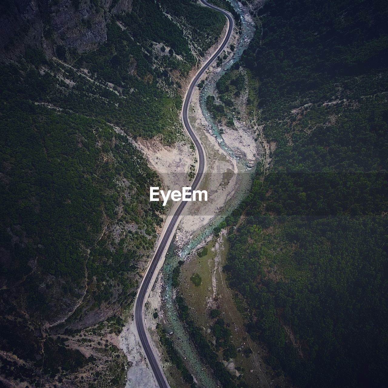 Aerial view of winding road amidst mountains