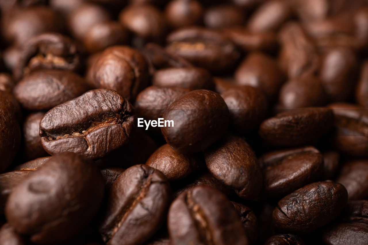 Close up of group black coffee beans. strong black espresso, grounds of coffee background, texture