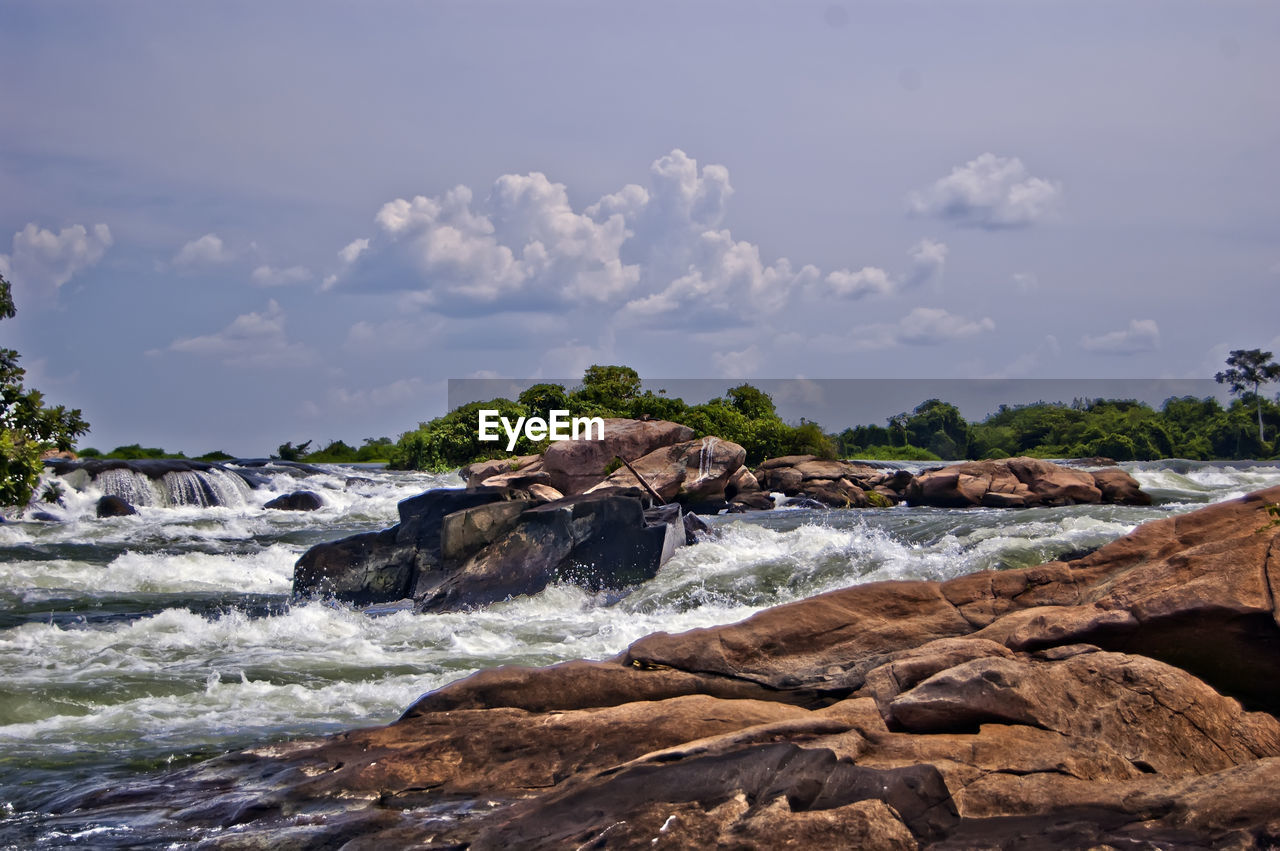 SCENIC VIEW OF ROCKS ON SHORE AGAINST SKY