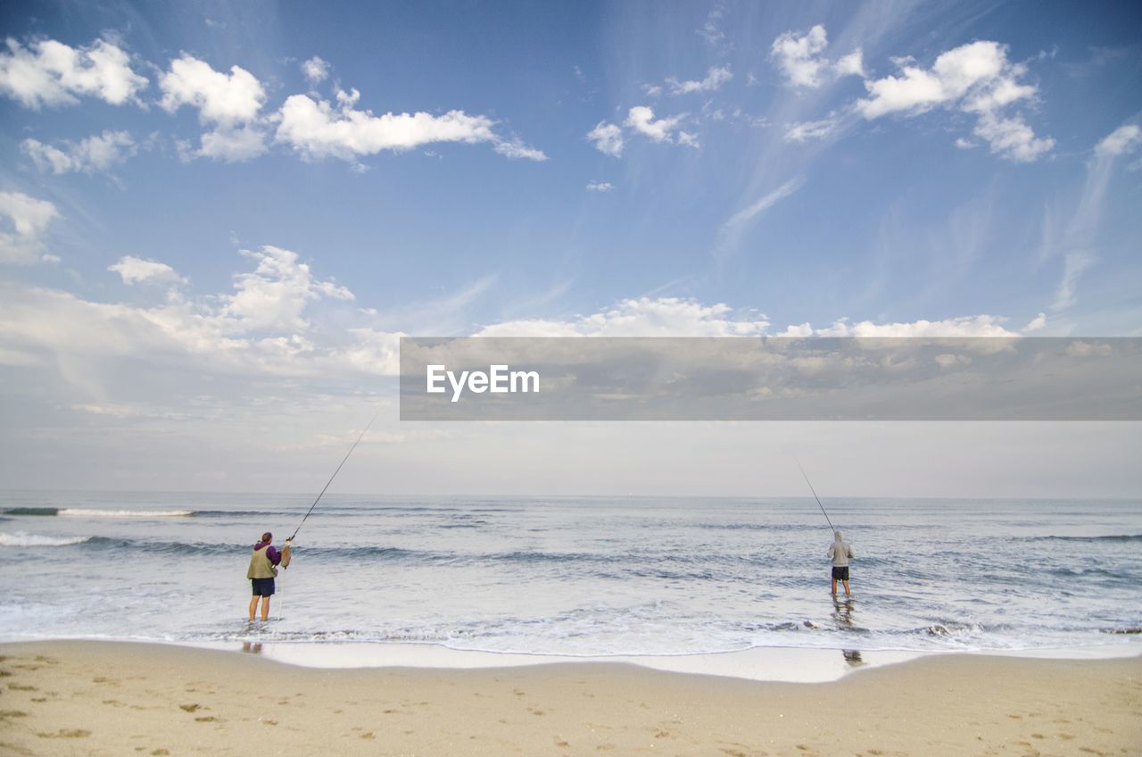 MAN FISHING ON BEACH