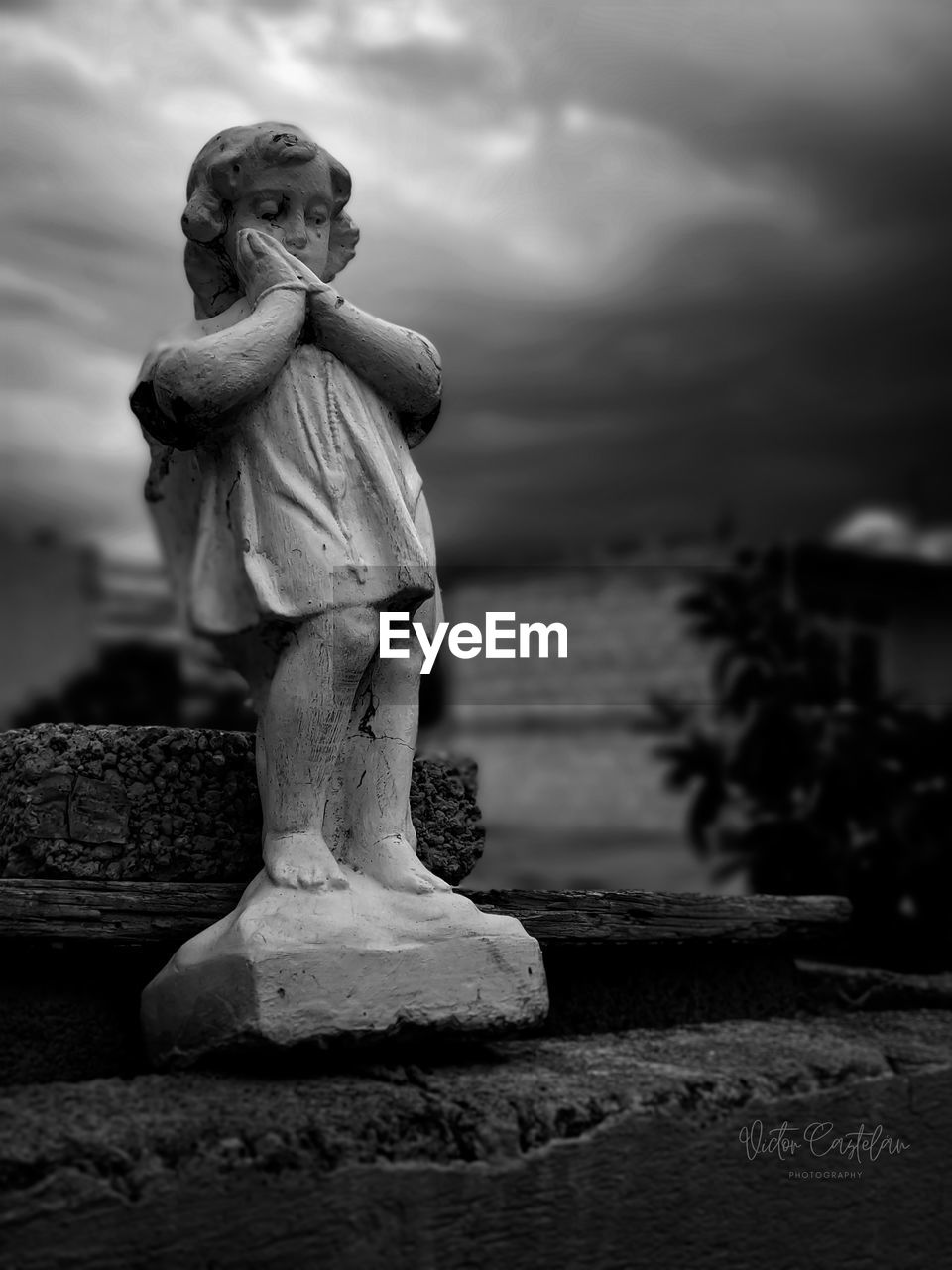 black and white, black, monochrome, statue, cloud, sculpture, monochrome photography, sky, white, darkness, human representation, monument, representation, nature, person, child, religion, craft, childhood, creativity, sadness, architecture, stone material, outdoors, sitting, human face, spirituality, history, male likeness