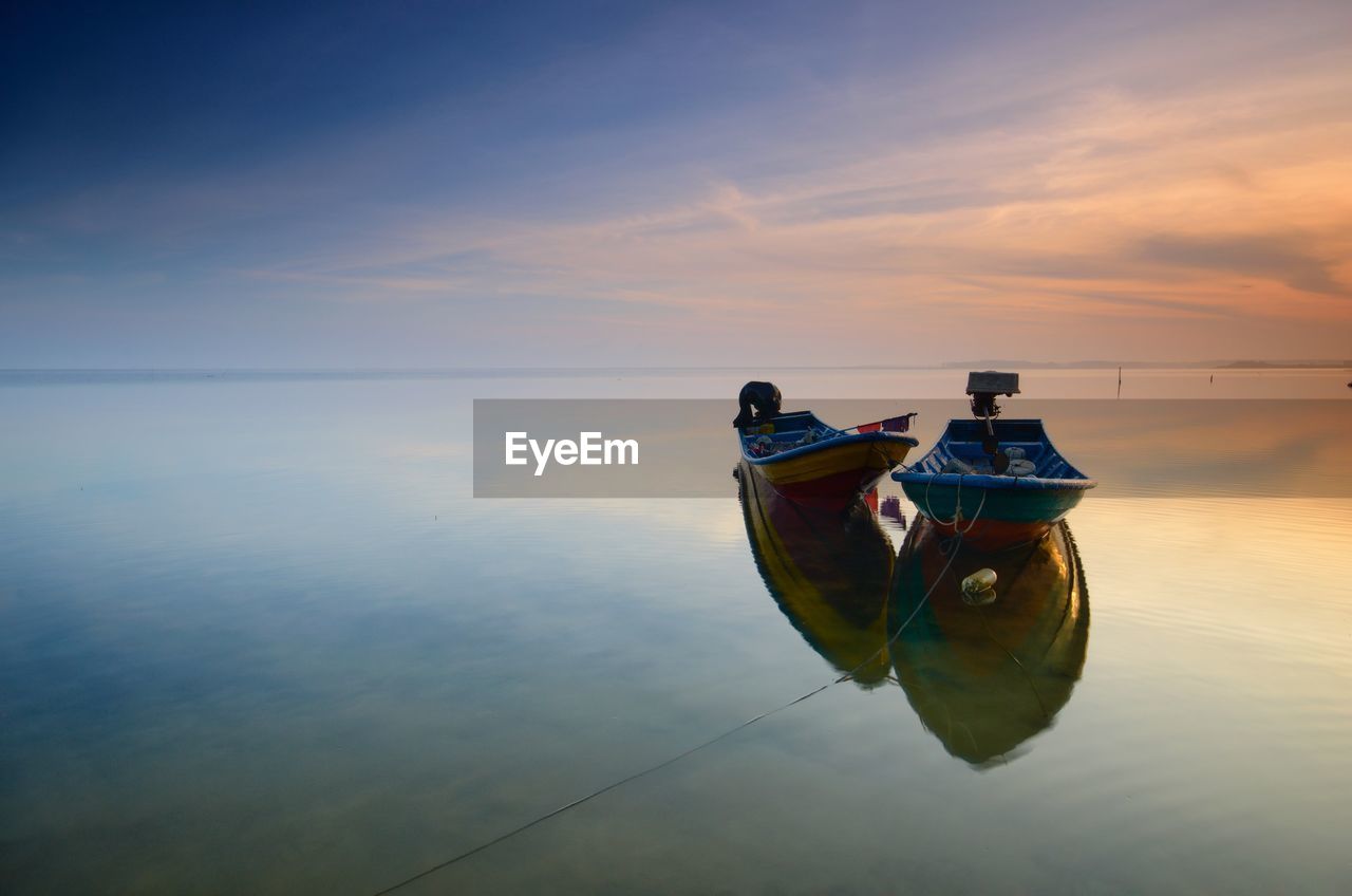 SHIP IN SEA AGAINST SKY DURING SUNSET